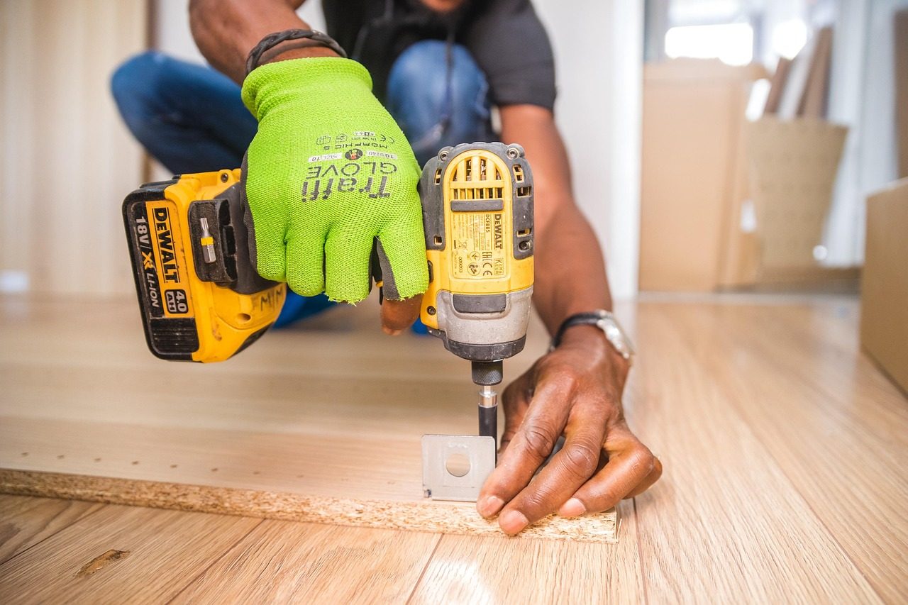 This image is of a Handyman from Handyman Services assembling flat packed furniture.
