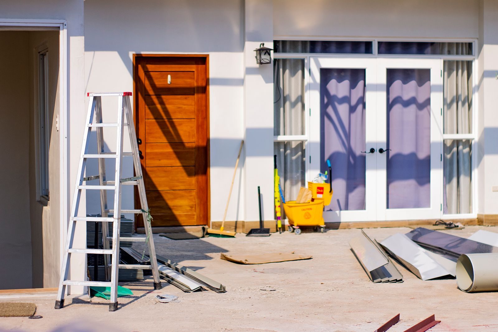Chickasaw Gardens Neighborhood remodeling services Front entrance of a house under renovation with tools and materials scattered around.