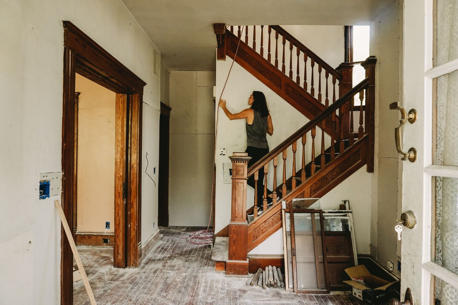 Buntyn Station Neighborhood handyman services A woman working on home renovation featuring a wooden staircase.